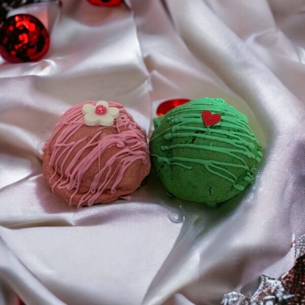 Two balls of yarn are on a satin cloth.