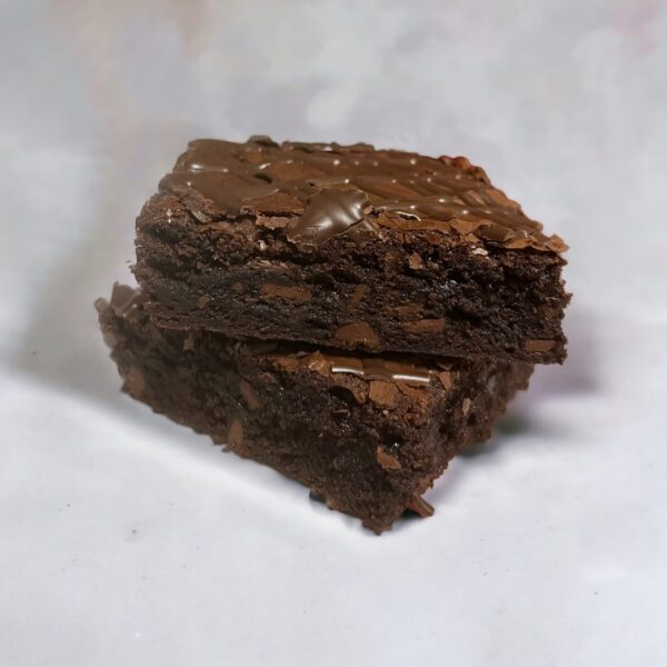 A close up of two brownies on top of each other.