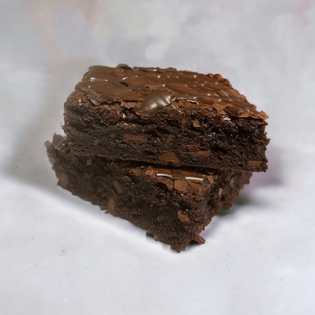 A close up of two brownies on top of each other.