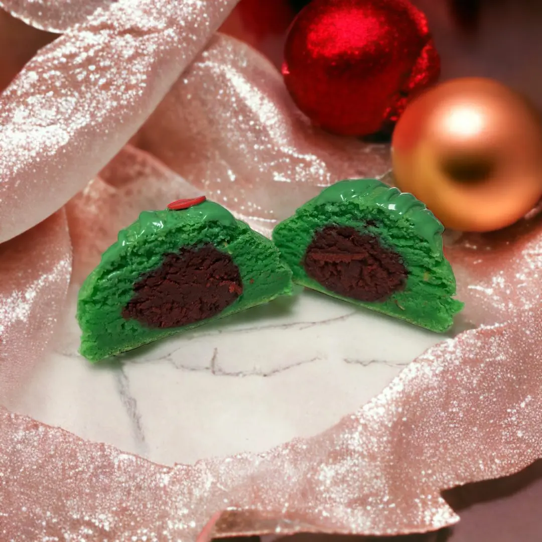 A close up of some green cookies on top of a plate