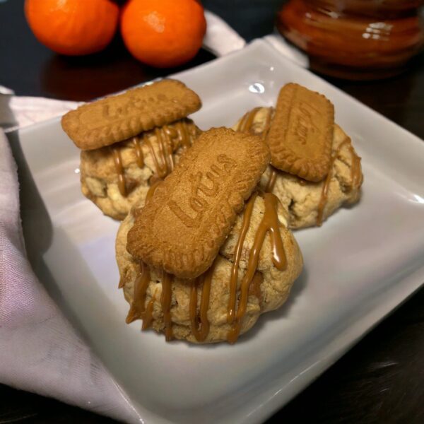 A plate of cookies with caramel on top.