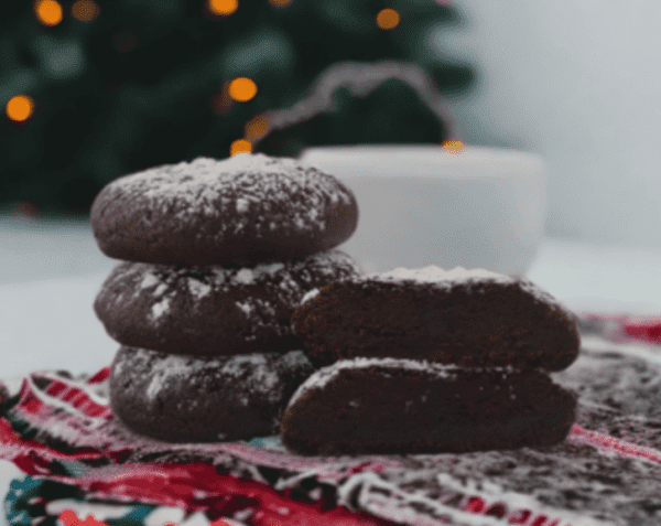 A stack of chocolate cookies on top of a table.