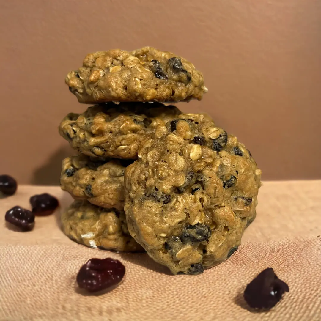 A stack of cookies with raisins on top.