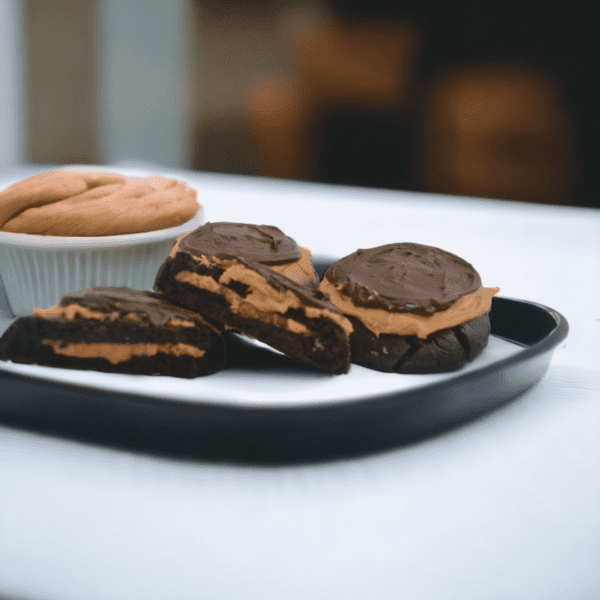 A plate of cookies and some chocolate on the table