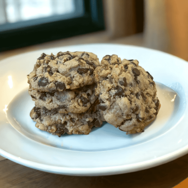 A white plate topped with three cookies on top of it.