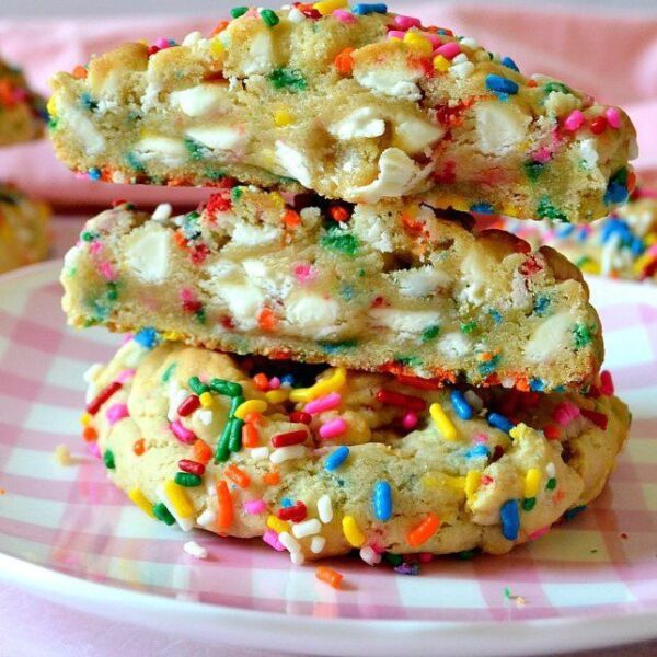 A plate of cookies with sprinkles on them.