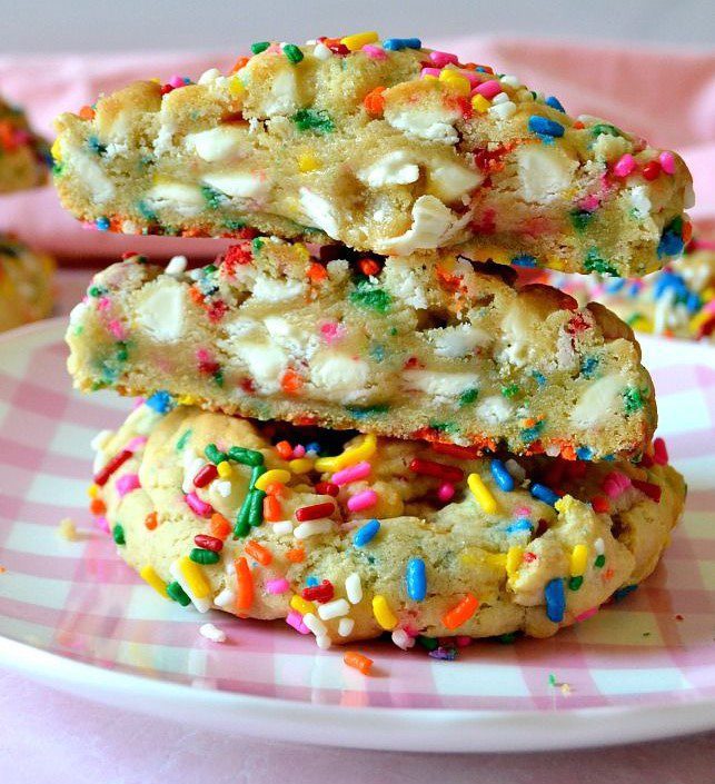 A plate of cookies with sprinkles on them.