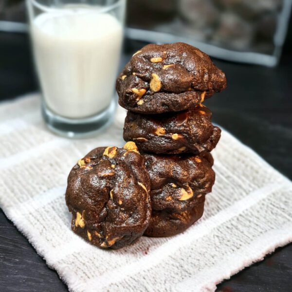 A stack of chocolate cookies on top of a napkin.