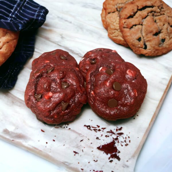 A close up of two cookies on a cutting board