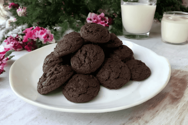 A plate of chocolate cookies on top of a table.