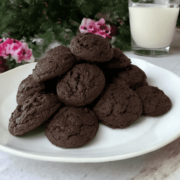 A plate of chocolate cookies on top of a table.