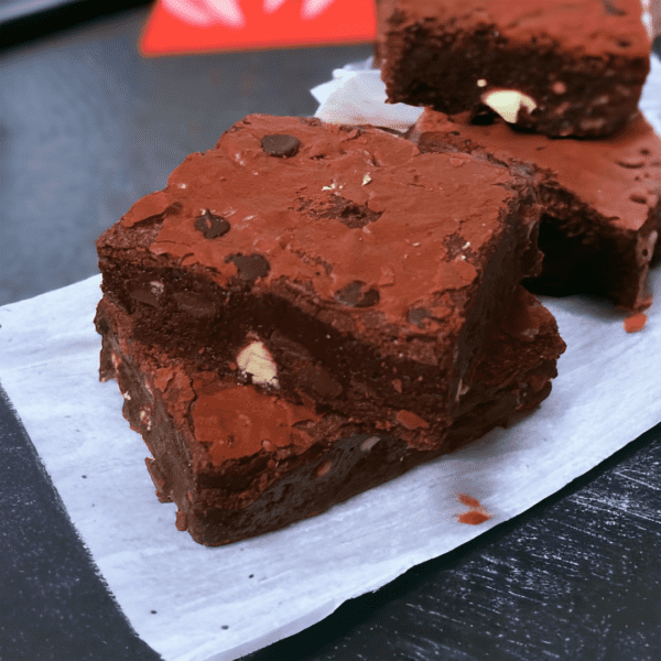 A close up of some brownies on a paper