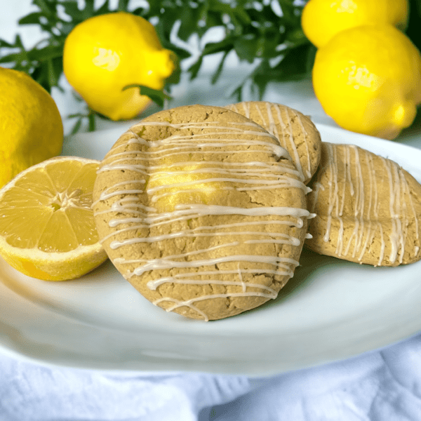 A plate of cookies with lemon slices on top.