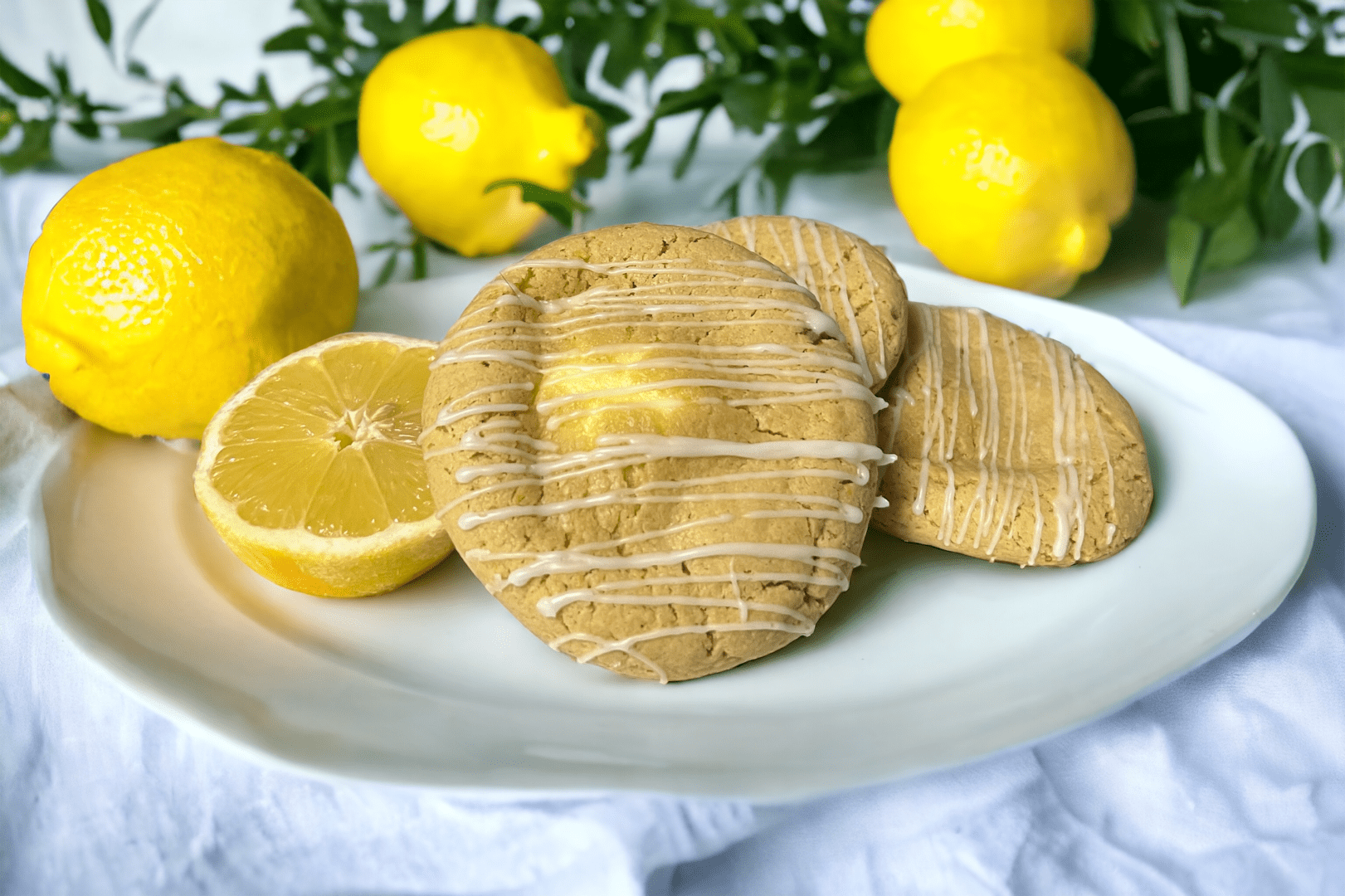 A plate of cookies with lemon slices on top.