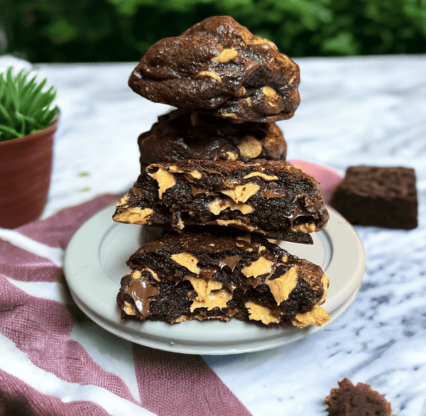 A plate of brownies stacked on top of each other.