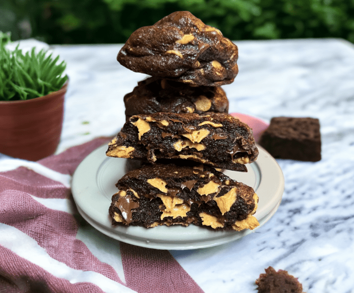 A plate of brownies stacked on top of each other.