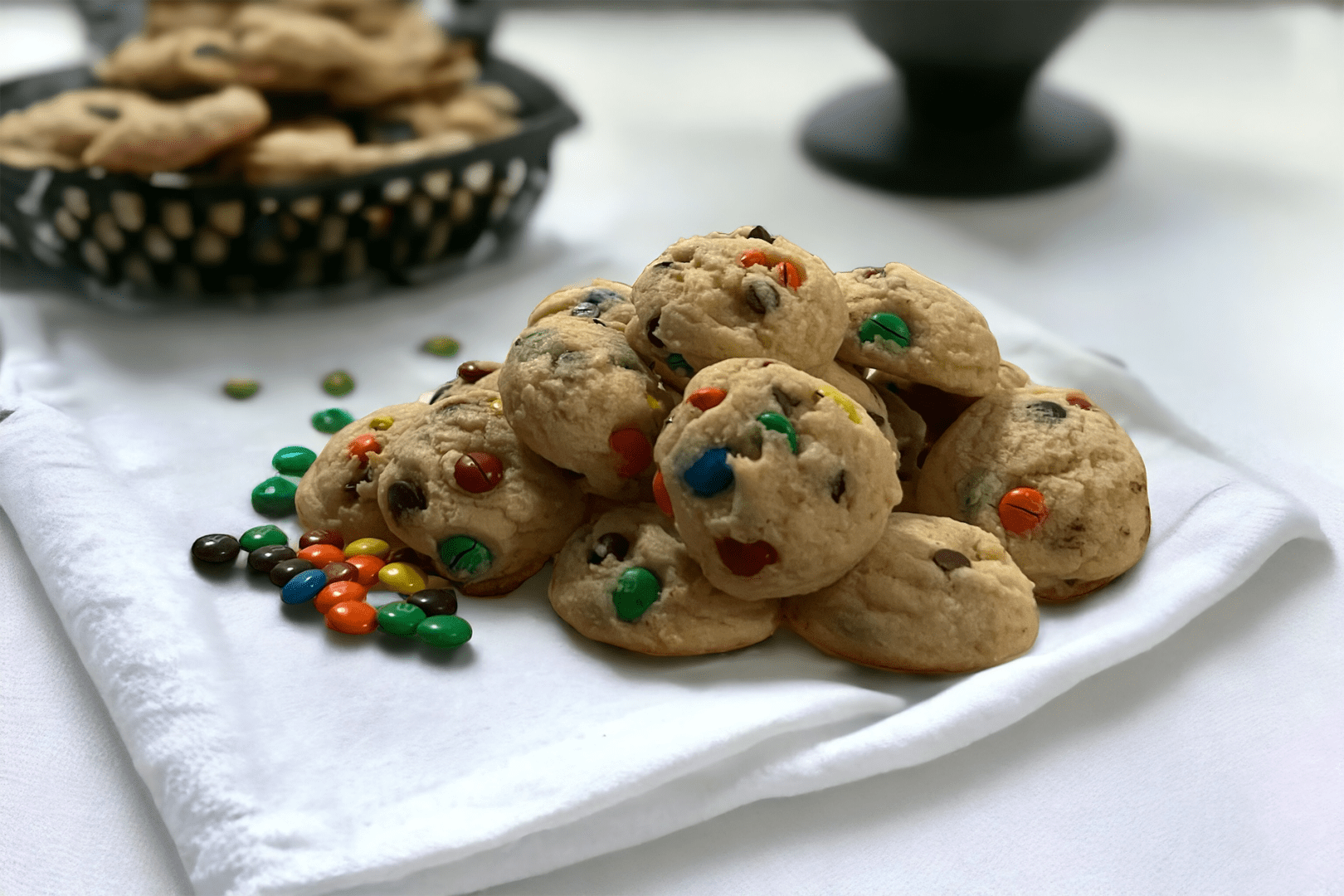 A plate of cookies with m & ms on top.