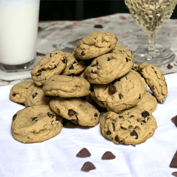 A pile of chocolate chip cookies on top of a table.