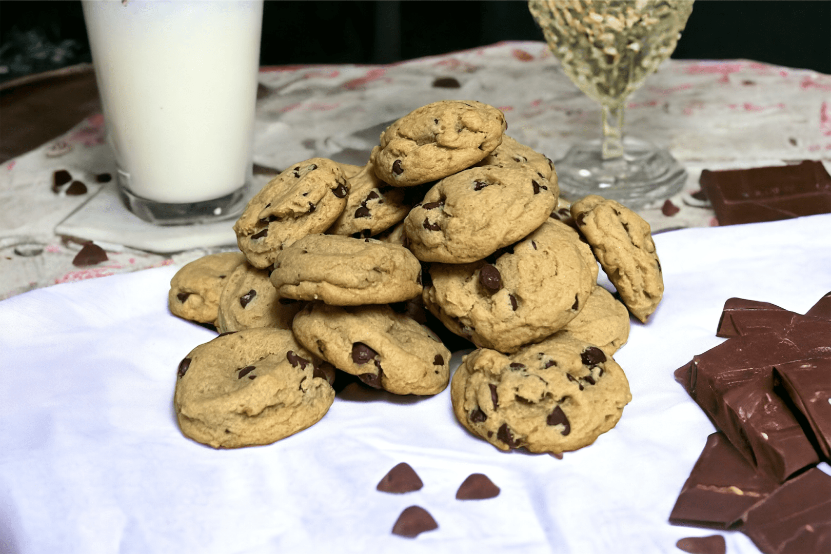 A pile of chocolate chip cookies on top of a table.