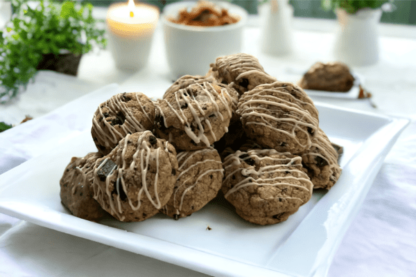 A white plate topped with cookies covered in icing.