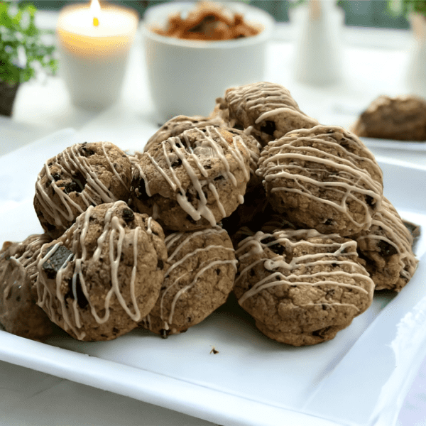 A white plate topped with cookies covered in icing.