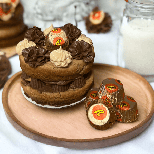 A plate of cookies and chocolates on top of the table.