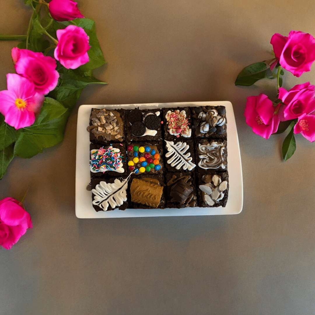 A box of chocolates and flowers on the table.