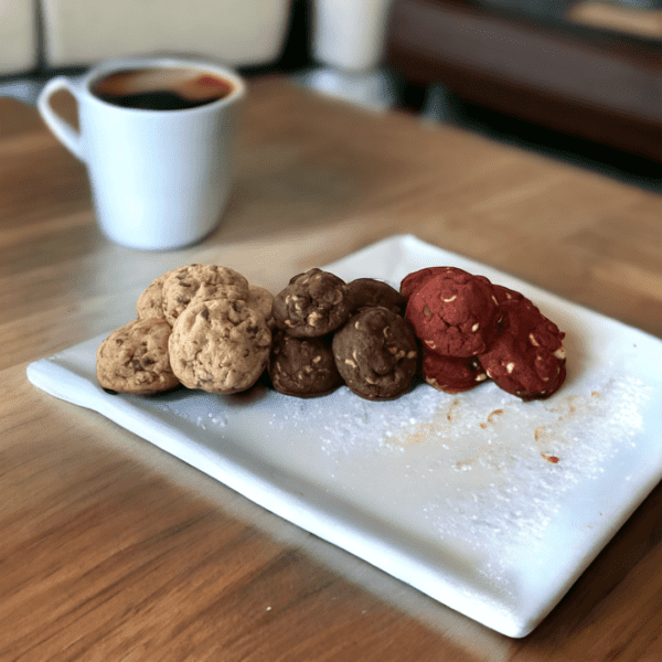 A white plate with cookies on it and coffee